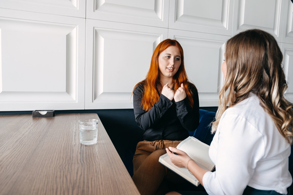 woman talking to therapist about mental health problems confidently